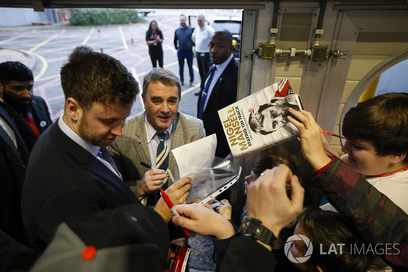 Nigel Mansell signs autographs for fans
