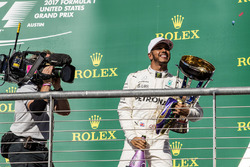 race winner Lewis Hamilton, Mercedes AMG F1 celebrates on the podium with the trophy, running shoes