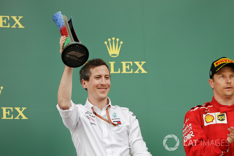 The Mercedes delegate lifts the Constructors trophy alongside Kimi Raikkonen, Ferrari, 2nd position, on the podium