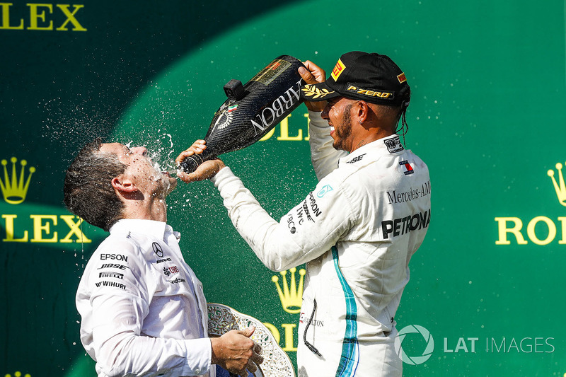 Lewis Hamilton, Mercedes AMG F1, 1st position, pours Champagne over his team mate on the podium
