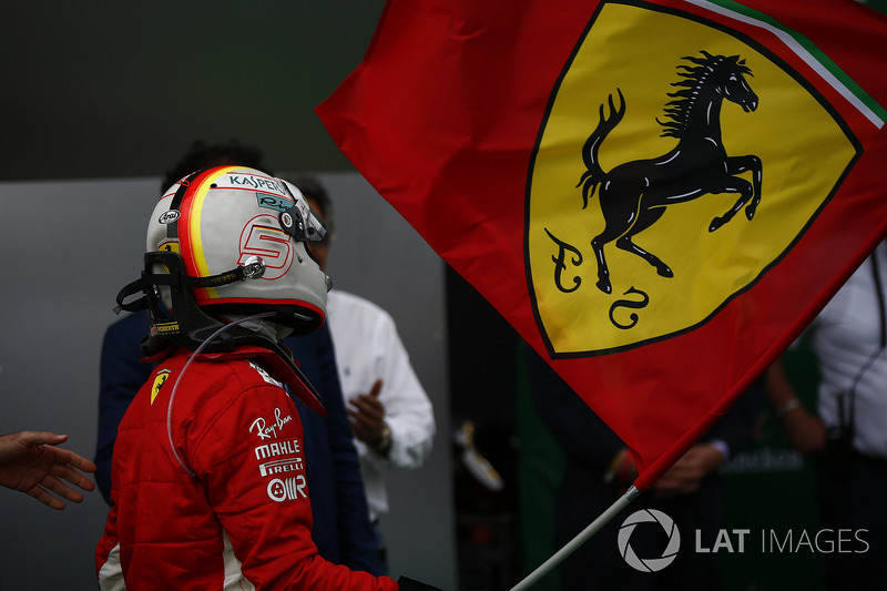 Sebastian Vettel, Ferrari, 1st position, waves the Ferrari flag in Parc Ferme