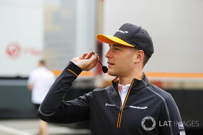 Stoffel Vandoorne, McLaren, and Fernando Alonso, McLaren, play darts