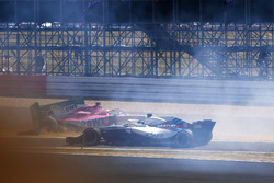 Sergio Perez, Force India VJM11, crashes into a advertising board at the start, as Lance Stroll, Williams FW41 passes by