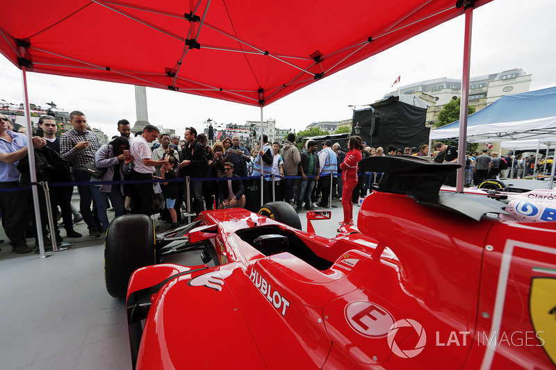 Fans inspect and photograph the Ferrari SF70H on the Scuderia Ferrari stand