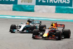 Max Verstappen, Red Bull Racing RB13, passes Lewis Hamilton, Mercedes AMG F1 W08 for the lead