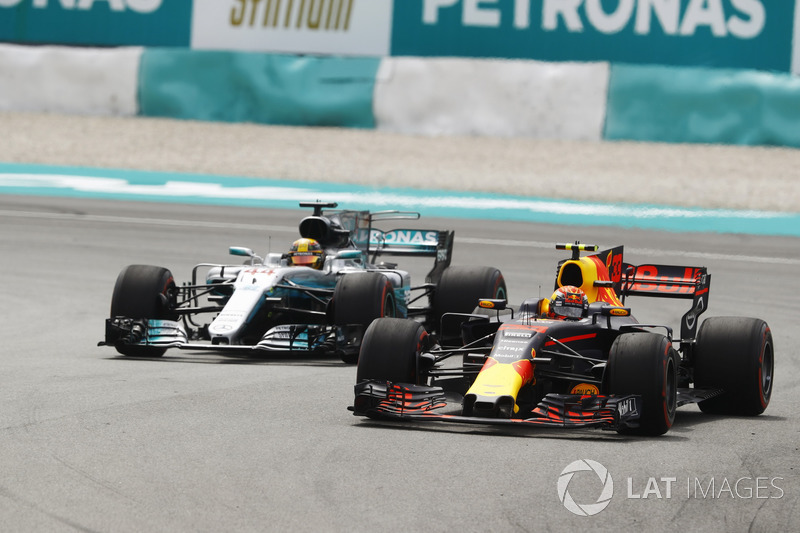 Max Verstappen, Red Bull Racing RB13, passes Lewis Hamilton, Mercedes AMG F1 W08 for the lead