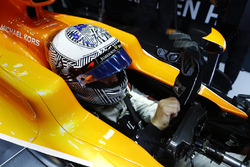Fernando Alonso, McLaren, puts on his gloves in his cockpit