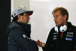 Sergio Perez, Force India, talks to a Force India team member