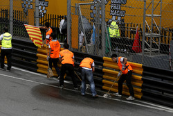 Marshalls try to clean the track