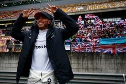 Lewis Hamilton, Mercedes AMG, celebrates victory in front of a grandstand filled with fans waving British flags