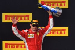 Kimi Raikkonen, Ferrari celebrates on the podium with the trophy