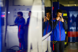 A Toro Rosso engineer using his phone