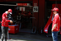 Sebastian Vettel, Ferrari, takes a picture of Kimi Raikkonen, Ferrari, on a vintage camera in the pi