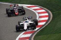 Felipe Massa, Williams FW40, leads Romain Grosjean, Haas F1 Team VF-17