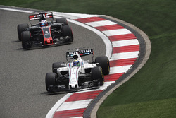 Felipe Massa, Williams FW40, leads Romain Grosjean, Haas F1 Team VF-17