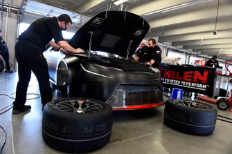 Team members make adjustments to the Nascar Next Gen car