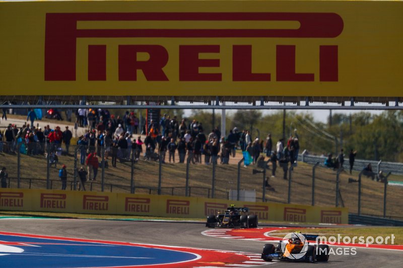 Lando Norris, McLaren MCL34, leads Kevin Magnussen, Haas F1 Team VF-19