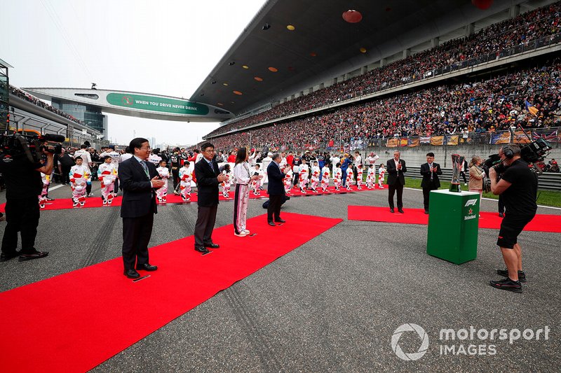 The national anthem is sung on the grid prior to the start