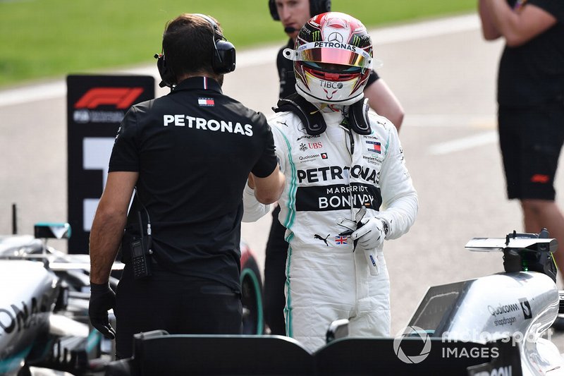 Lewis Hamilton, Mercedes AMG F1, is congratulated by a mechanic