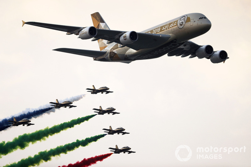 UAE display team Al Fursan escort an Airbus A380 of Etihad Airlines over the grid in their Aermacchi MB339A aircraft