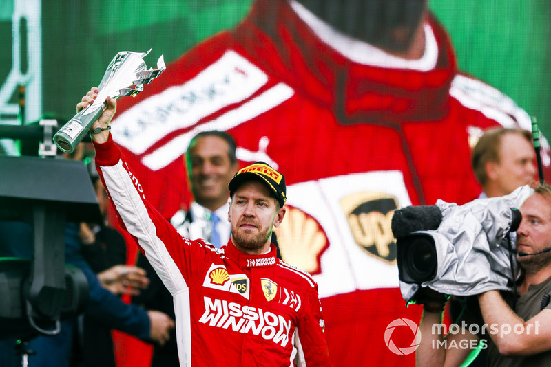 Sebastian Vettel, Ferrari, 2nd position, lifts his trophy on the podium