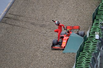 Charles Leclerc, Ferrari, climbs out of his car after crashing out