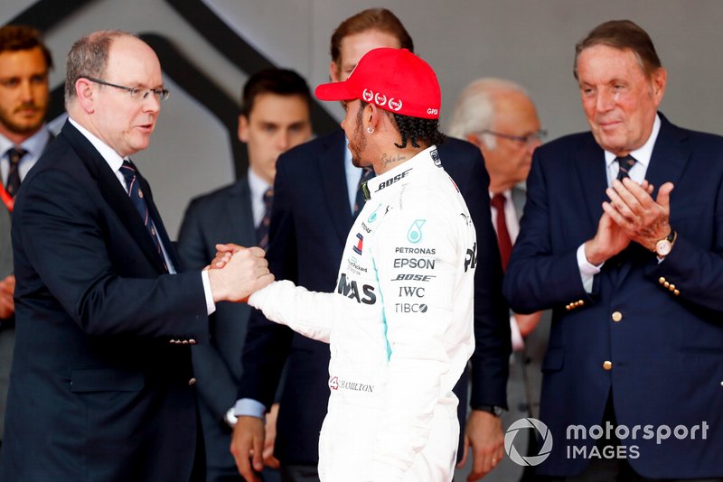 Lewis Hamilton, Mercedes AMG F1, 1st position, is greeted on the podium by Prince Albert II of Monaco