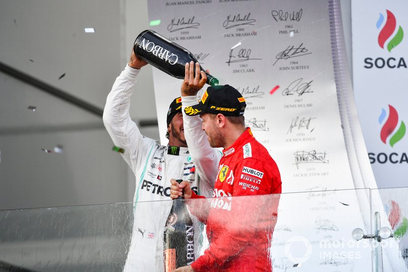 Lewis Hamilton, Mercedes AMG F1, 2nd position, pours Champagne over Sebastian Vettel, Ferrari, 3rd position, on the podium