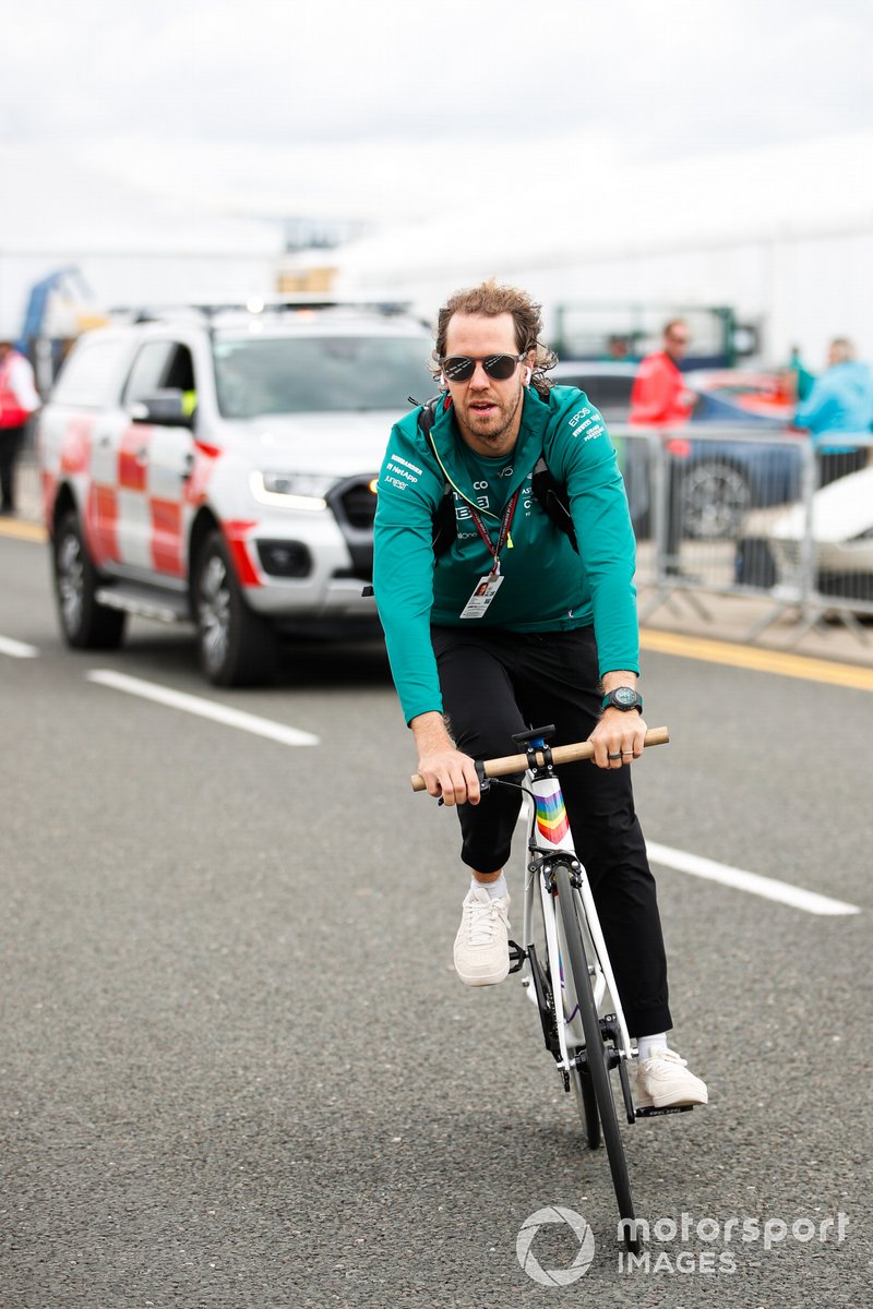 Sebastian Vettel, Aston Martin, cycles into the track