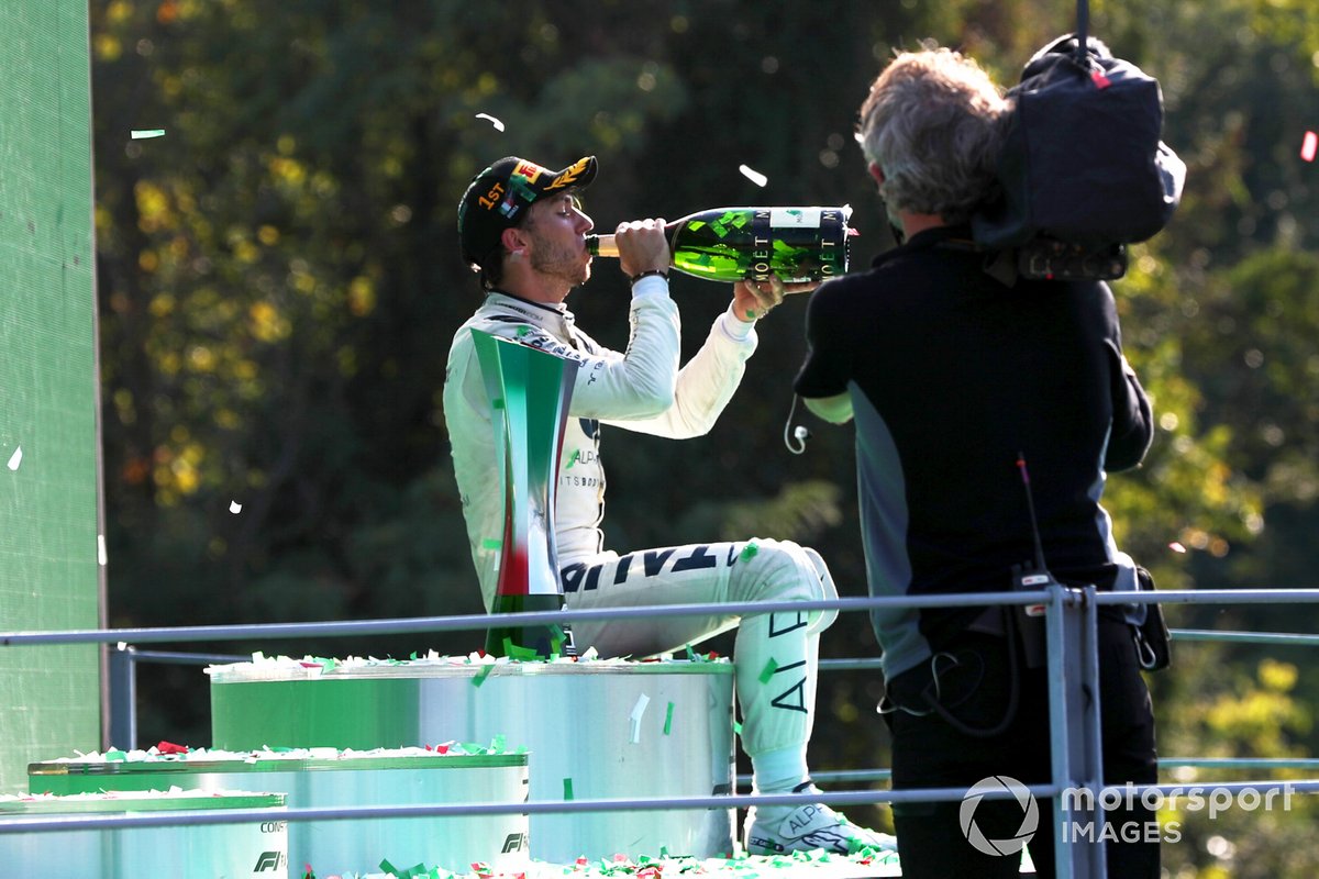 Pierre Gasly, AlphaTauri, 1st position, sits on the podium and drinks some Champagne