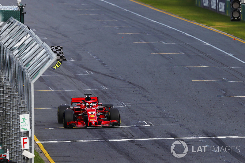 Sebastian Vettel, Ferrari SF71H, takes the chequered flag ahead of Lewis Hamilton, Mercedes AMG F1 W09