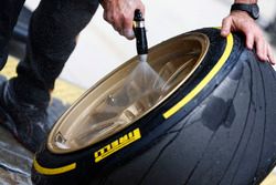 A Lotus team member works on the 18 inch wheels