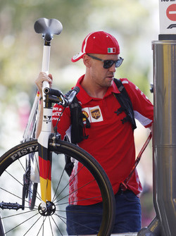 Sebastian Vettel, Ferrari, enters the paddock carrying a bicycle