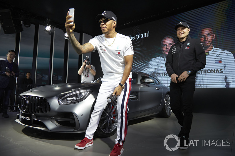 Lewis Hamilton, Mercedes AMG F1, and Valtteri Bottas, Mercedes AMG F1, on stage