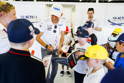 Esteban Ocon, Force India, signs autographs for the children