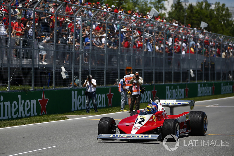 Jacques Villeneuve drives the Ferrari 312T3 raced by his father Gilles Villeneuve on a parade lap