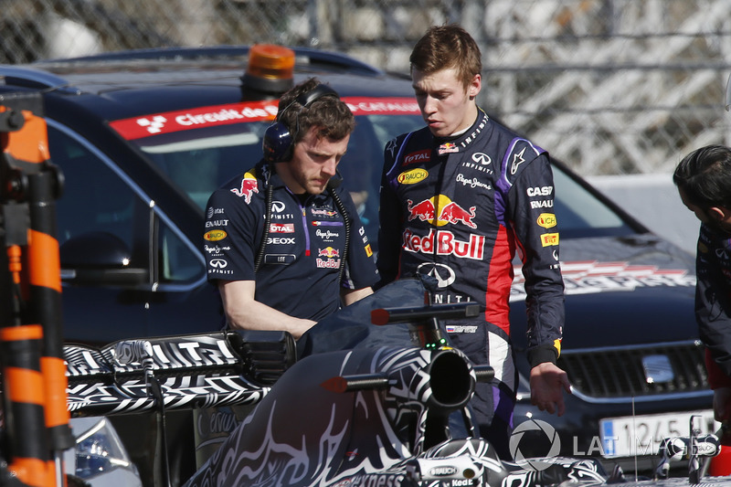 Daniil Kvyat, Red Bull Racing RB11, talks to a Red Bull team member after stopping on track