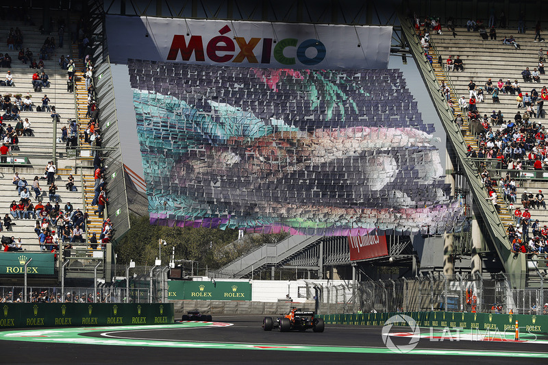 Fernando Alonso, McLaren MCL32, follows a Ferrari through the stadium section