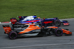 Fernando Alonso, McLaren MCL32 and Carlos Sainz Jr., Scuderia Toro Rosso STR12