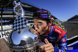 Takuma Sato, Andretti Autosport Honda celebrates his win of the Indy 500 by kissing the Borg-Warner Trophy on the yard of bricks
