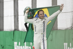 Felipe Massa, Williams, carries a Brazilian flag as he walks back to his garage in tears after crashing