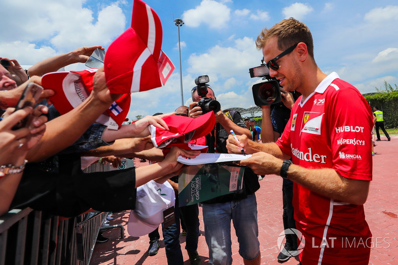 Sebastian Vettel, Ferrari sugns autographs for the fans