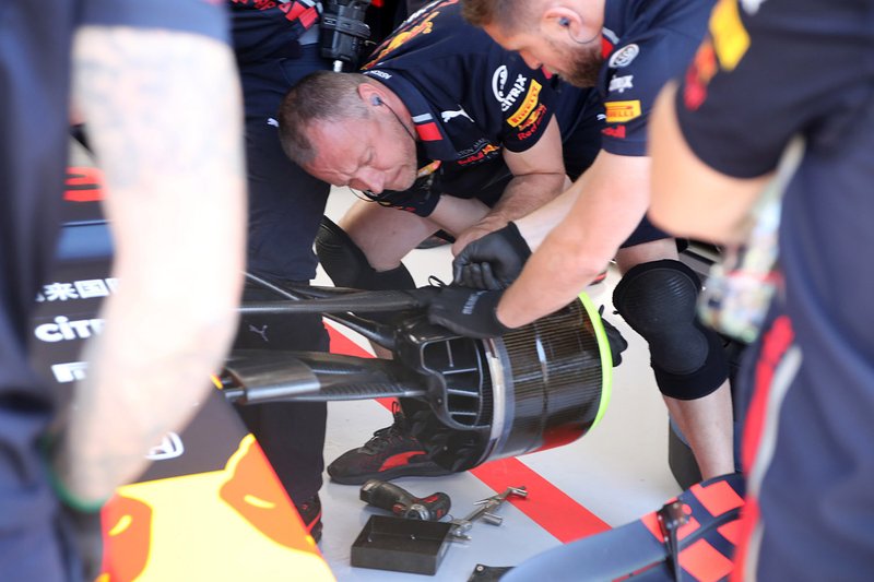 Red Bull Racing RB15 team members at work on the front brake drum