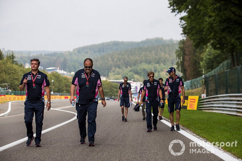 Racing Point team members walk the track