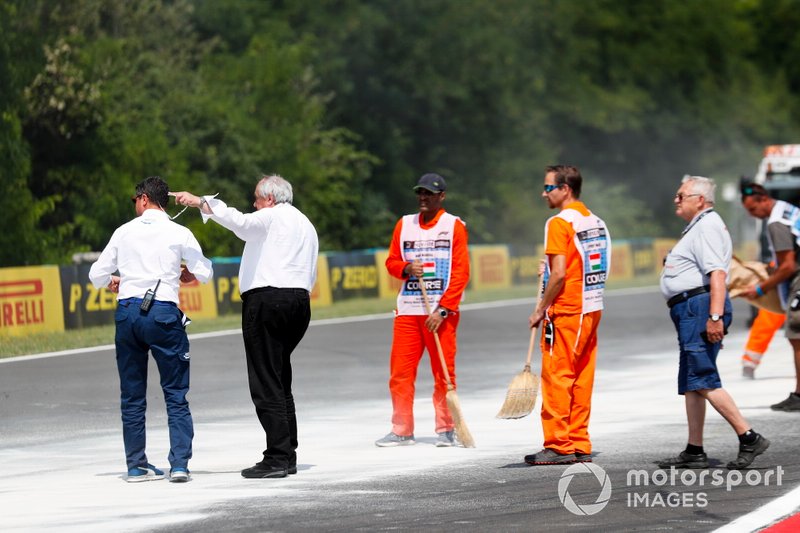 Michael Masi, Race Director inspects Marshals cleaning up oil spill from the F2 race
