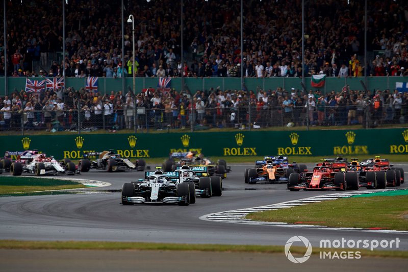 Valtteri Bottas, Mercedes AMG W10, leads Lewis Hamilton, Mercedes AMG F1 W10, Charles Leclerc, Ferrari SF90, Max Verstappen, Red Bull Racing RB15, Sebastian Vettel, Ferrari SF90, Pierre Gasly, Red Bull Racing RB15, and the rest of the field at the start