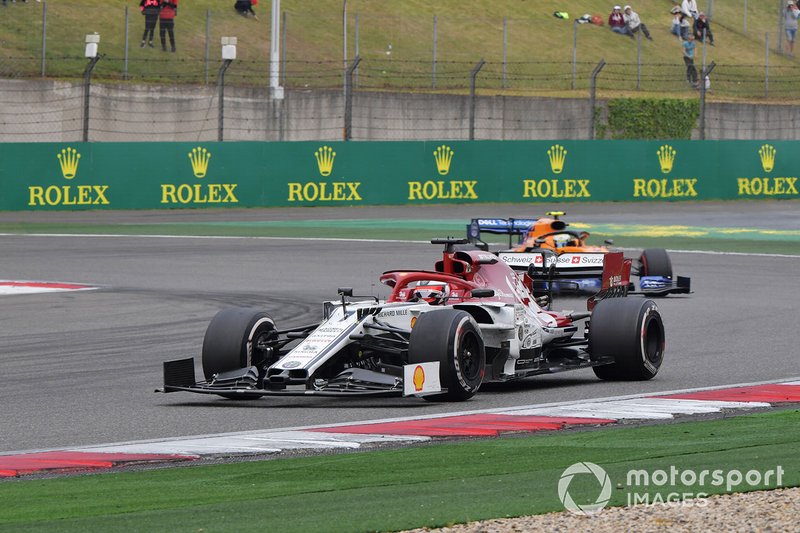 Kimi Raikkonen, Alfa Romeo Racing C38, leads Lando Norris, McLaren MCL34