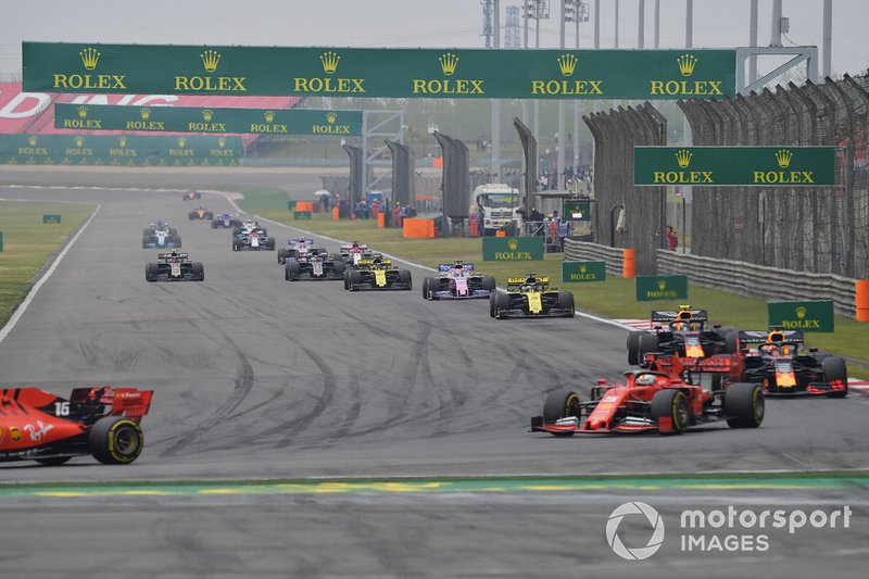 Charles Leclerc, Ferrari SF90, leads Sebastian Vettel, Ferrari SF90, Max Verstappen, Red Bull Racing RB15, Pierre Gasly, Red Bull Racing RB15, Daniel Ricciardo, Renault F1 Team R.S.19, Sergio Perez, Racing Point RP19, and the remainder of the field on the opening lap