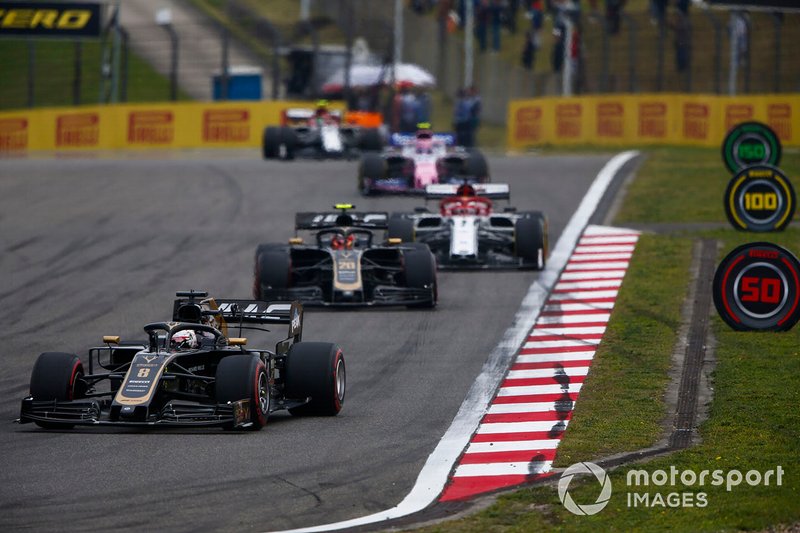 Romain Grosjean, Haas F1 Team VF-19, leads Kevin Magnussen, Haas F1 Team VF-19, and Kimi Raikkonen, Alfa Romeo Racing C38