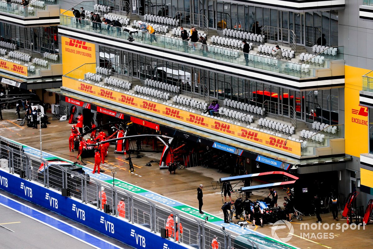 Carlos Sainz Jr., Ferrari SF21, and Fernando Alonso, Alpine A521, in the pit lane